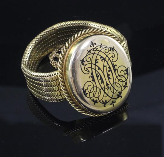 A Victorian gold mesh link mourning bracelet with central oval hinged compartment,